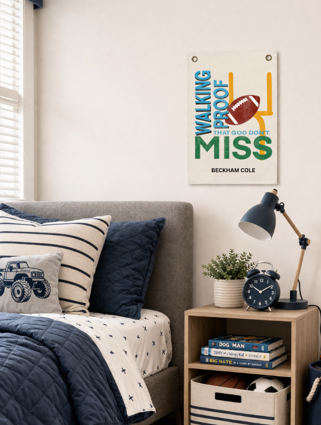 God Don't Miss personalized tapestry featuring a football design, displayed above a bed with navy blue bedding and a lamp.
