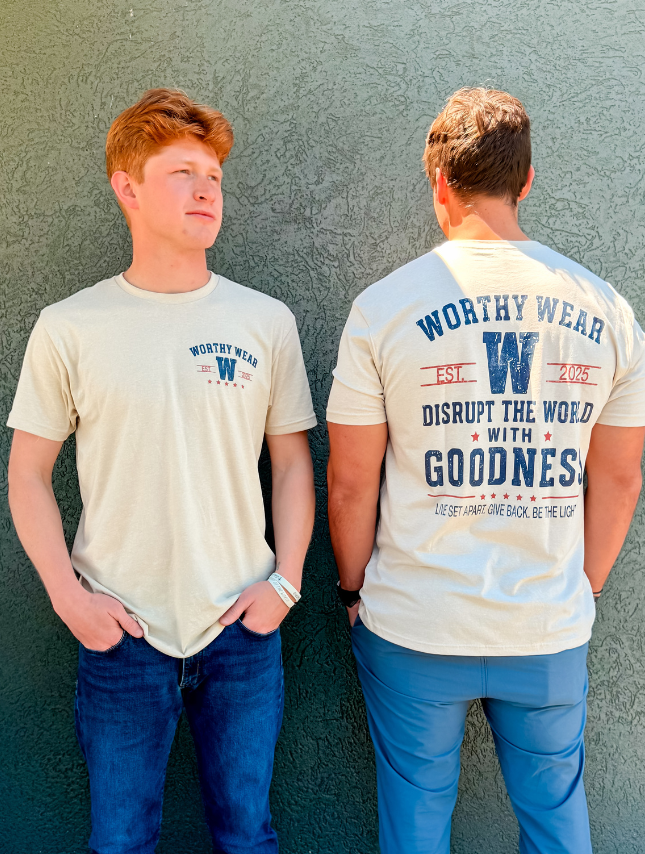 Vintage Goodness Tee in cream, featuring front and back designs with text and logo, worn by two models.
