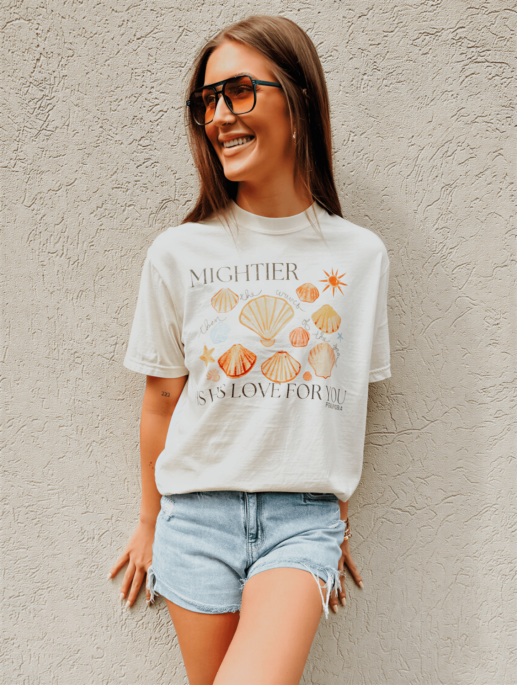 model wearing Mightier Is His Love Tee