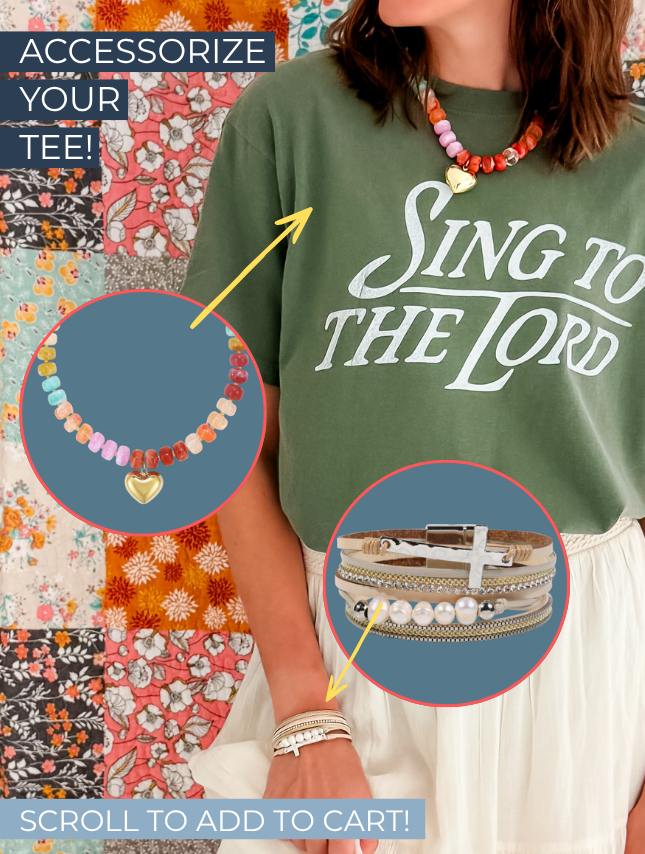 Green "Sing To The Lord" tee worn by a model, accessorized with colorful necklaces and bracelets against a patterned backg...