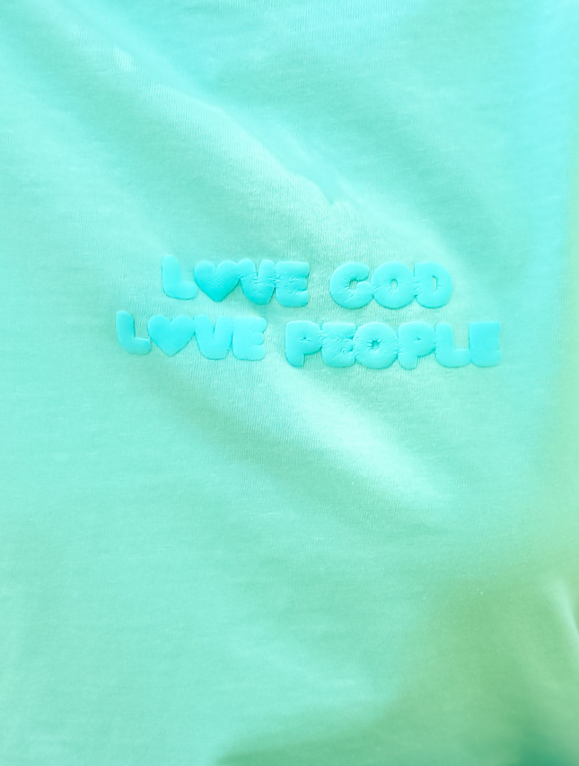 Light blue puff tee featuring the text "Love God Love People" in a raised, soft font.