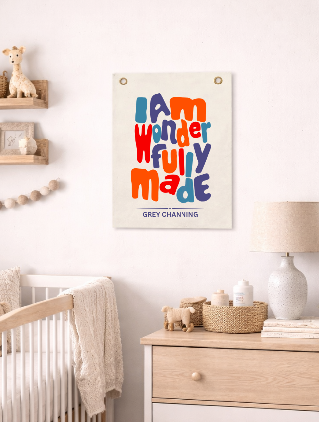 Personalized tapestry featuring colorful text "I am wonderfully made" on a neutral background, displayed in a nursery sett...