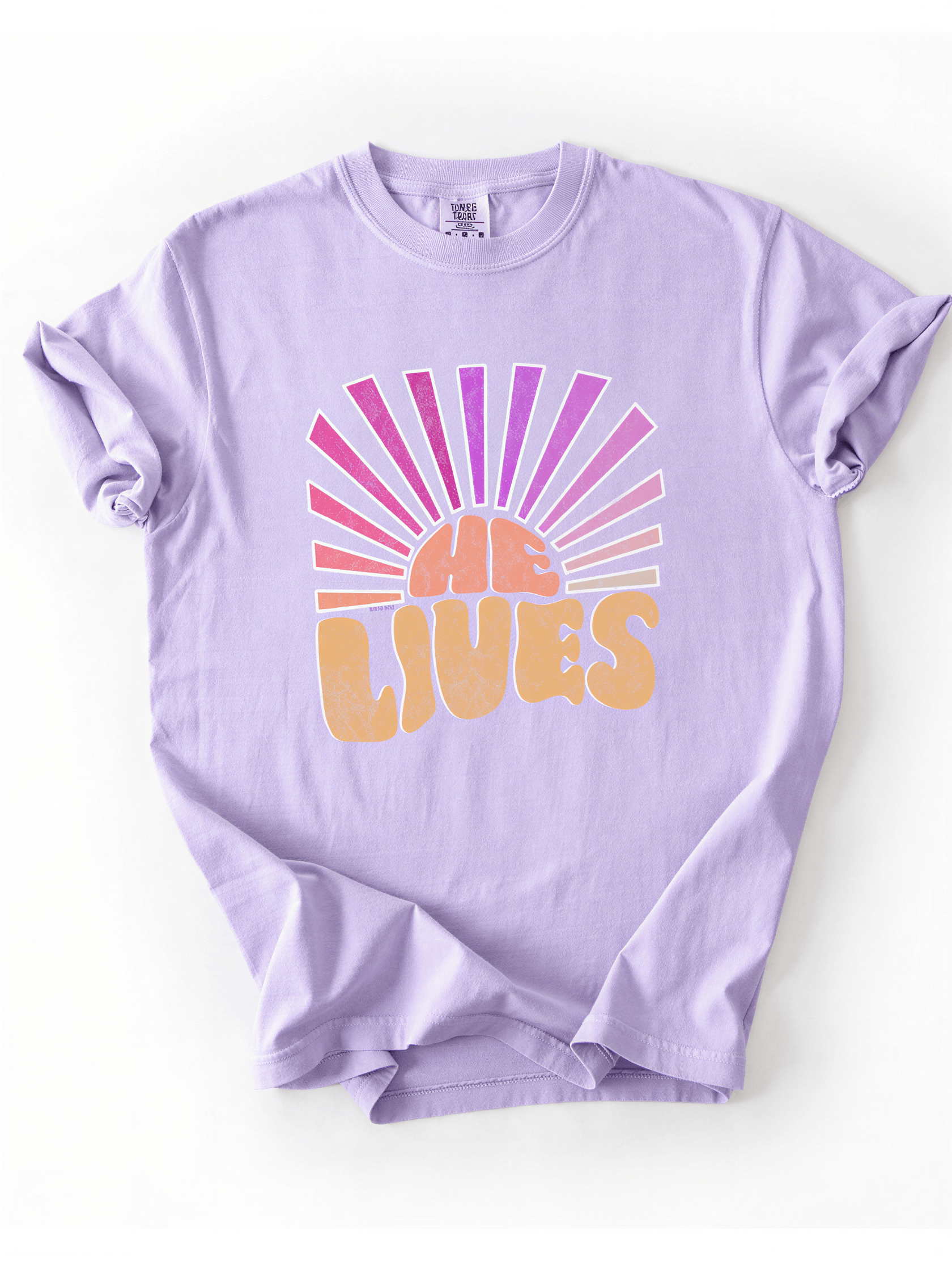 A purple t-shirt with a graphic design featuring the word 'LIVES' in stylized lettering, with a sunburst pattern in pink and orange behind the text.