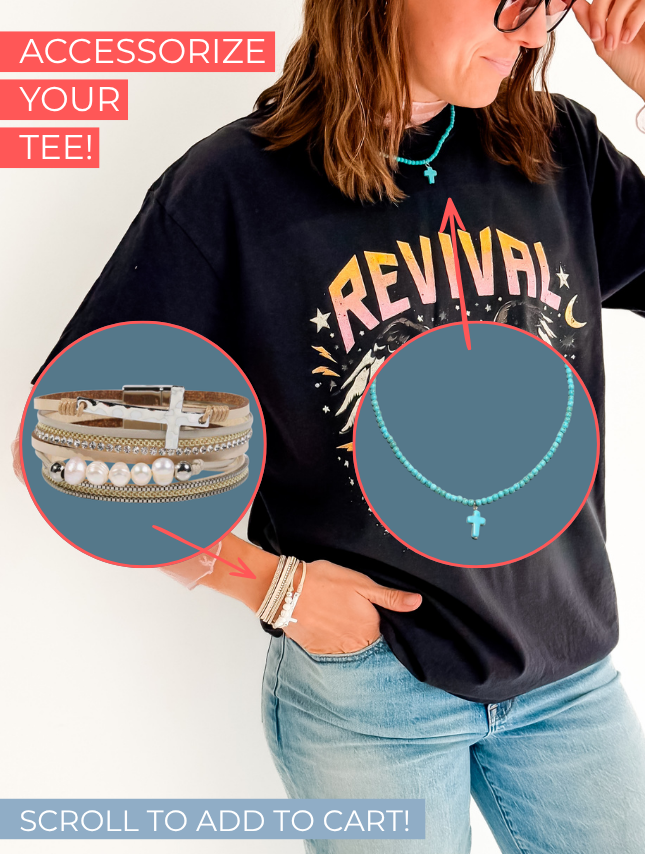 Revival World Tour tee in black, featuring colorful graphic text, worn with layered bracelets and a necklace.