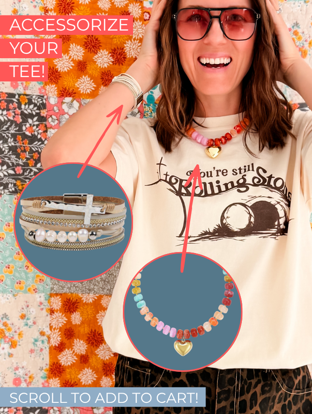 You're still rolling stones tee in cream, featuring a graphic design with text and a round neckline, worn by a smiling woman.