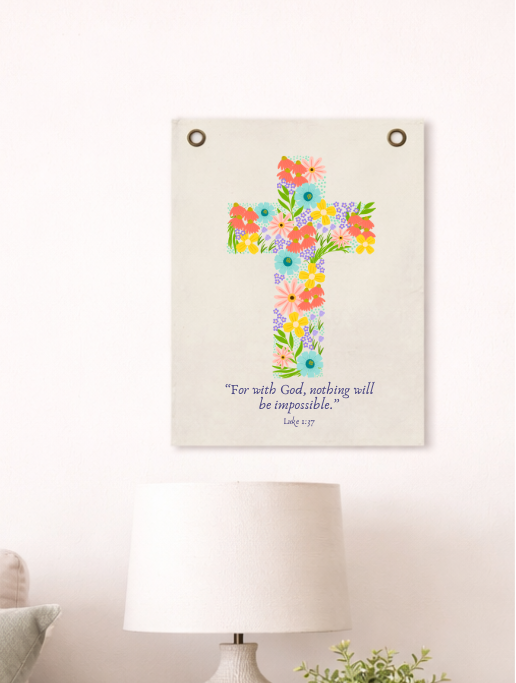 Floral cross wall art in a living room setting with a lamp and plant.