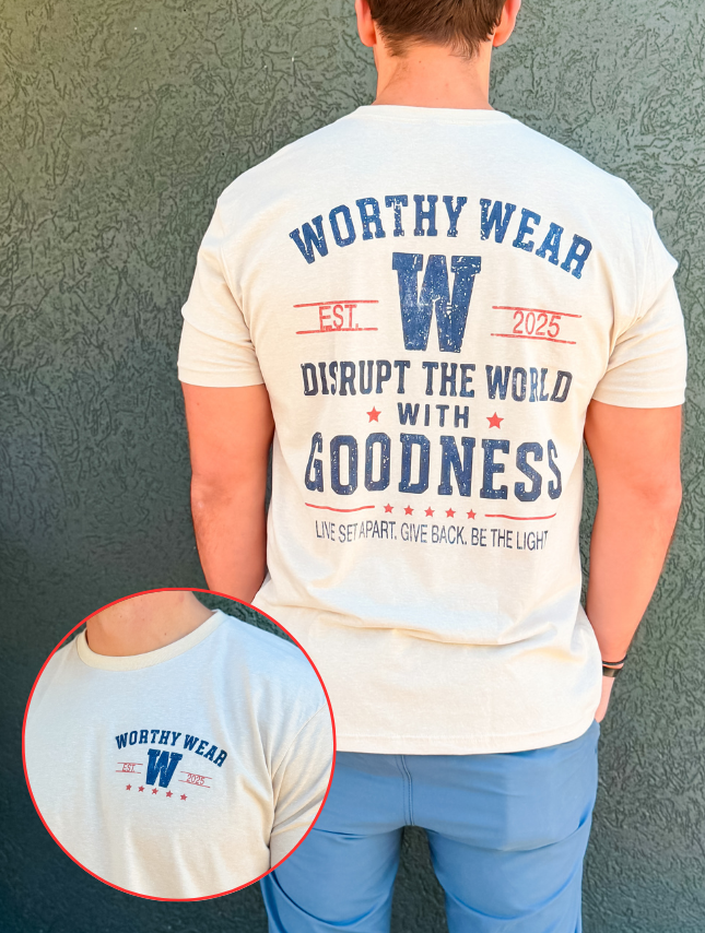 Cream vintage Goodness tee featuring a large "W" logo and text on the back, with a smaller logo on the front.