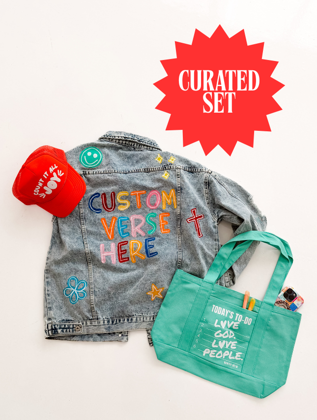 The Wear Your Testimony Bundle includes a denim jacket with colorful embroidery, a red cap, and a green tote bag.