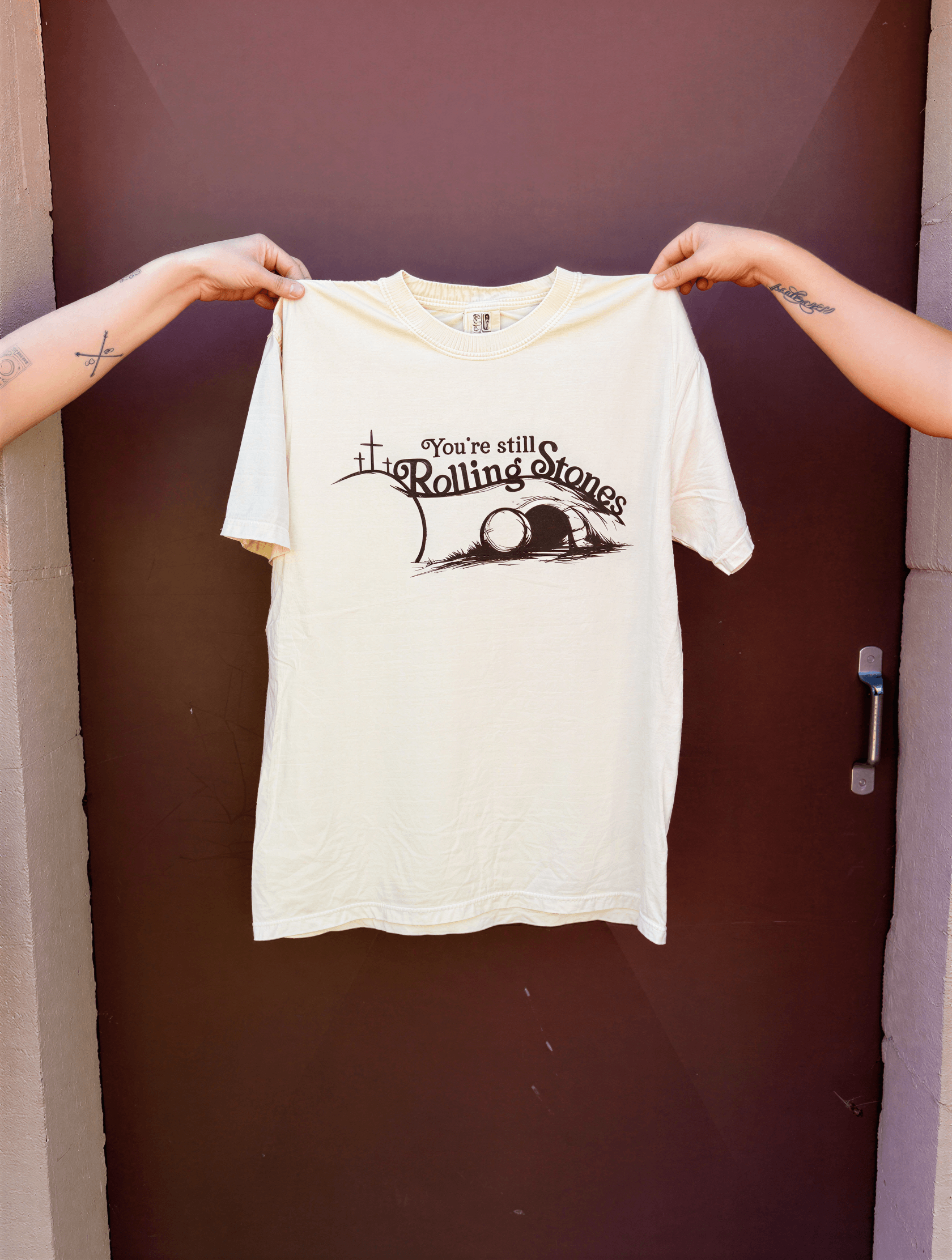 you're still rolling stones tee being held up