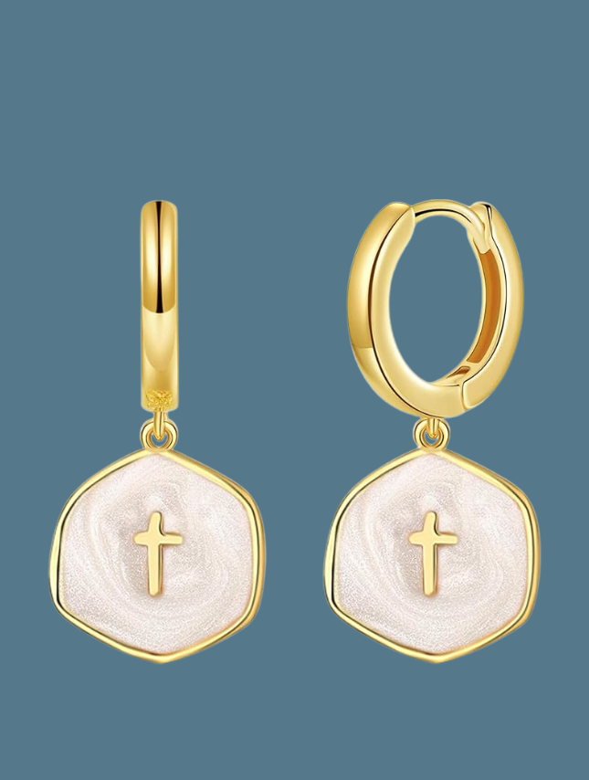 White pearl cross drop earrings with gold hoop and hexagonal design, featuring a textured surface and a small cross.