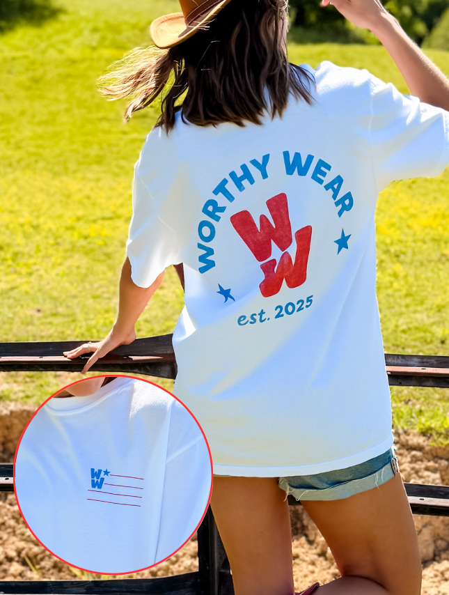 All-American WW tee in white with red and blue graphics, featuring "Worthy Wear" and "est. 2025" on the back.