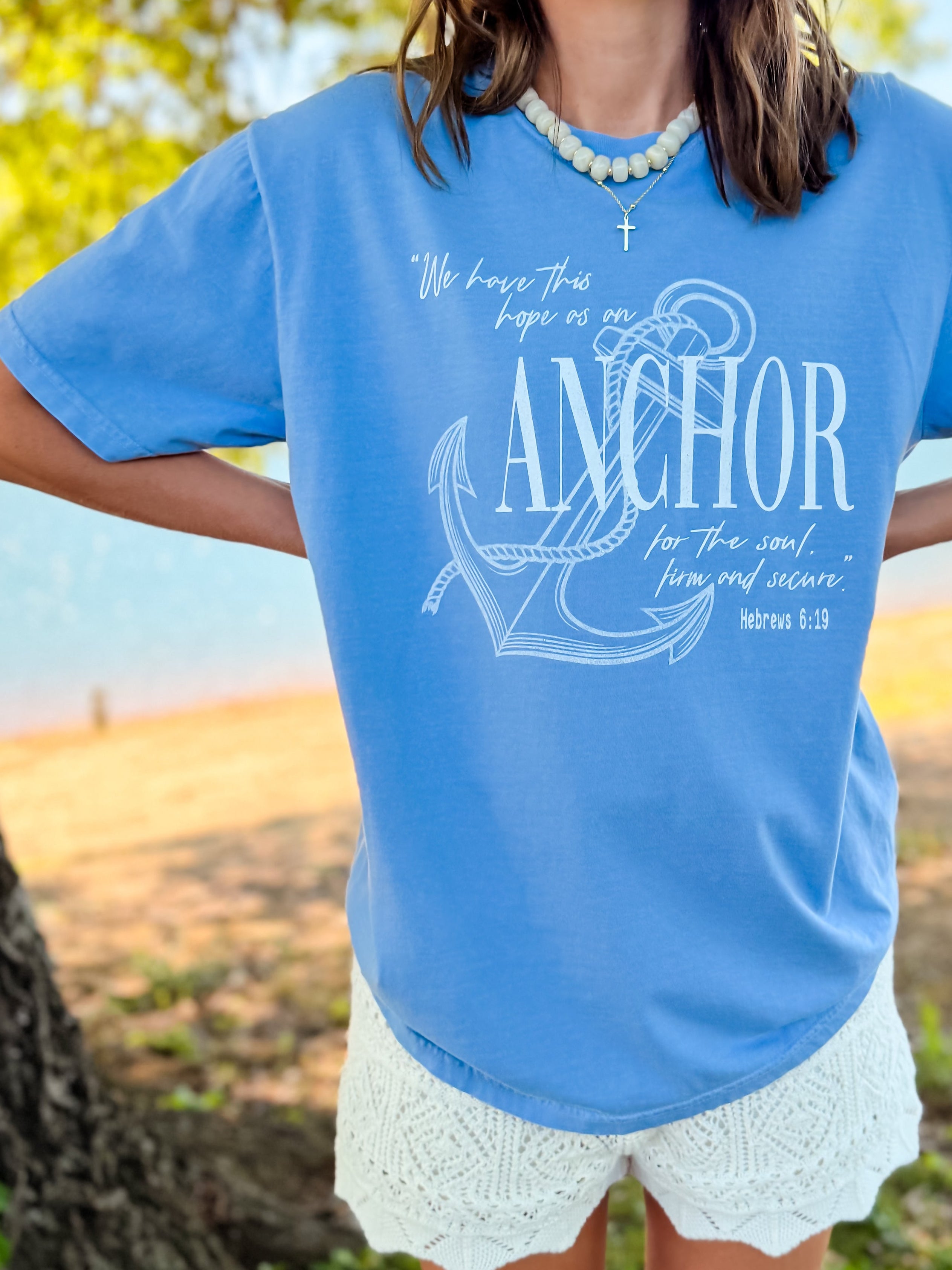 Light blue tee featuring an anchor graphic and the text "We have this hope as an anchor for the soul, firm and secure.