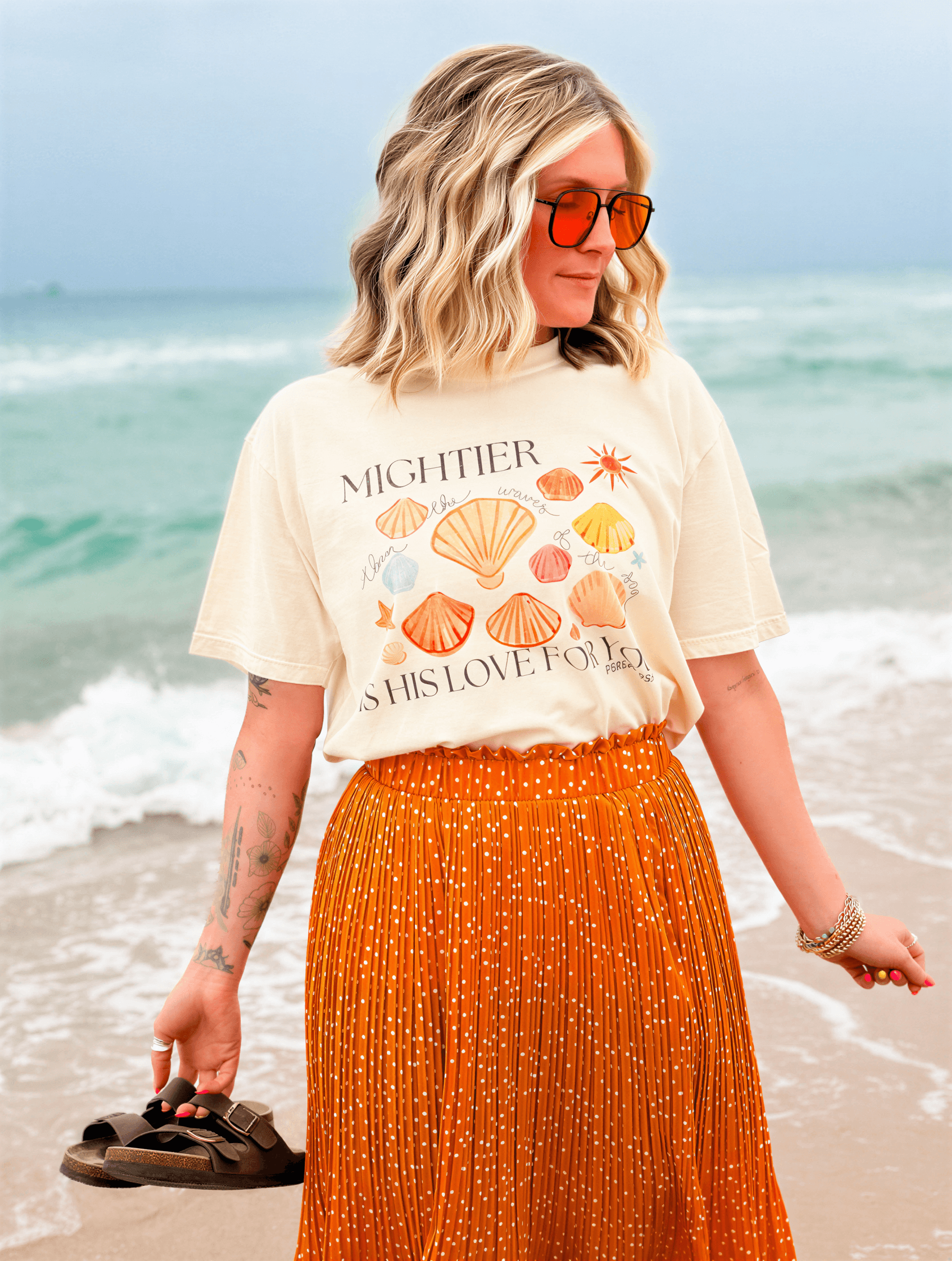 model wearing Mightier Is His Love Tee