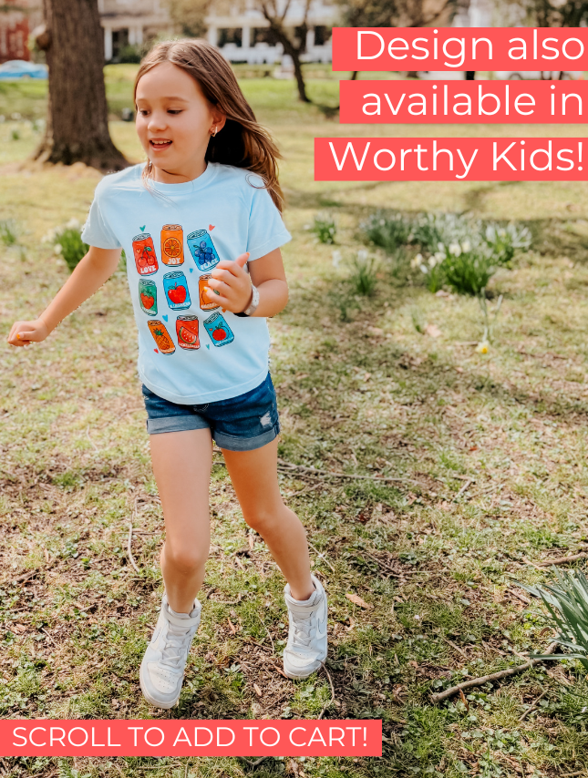 Child wearing a light blue t-shirt with colorful graphics outdoors