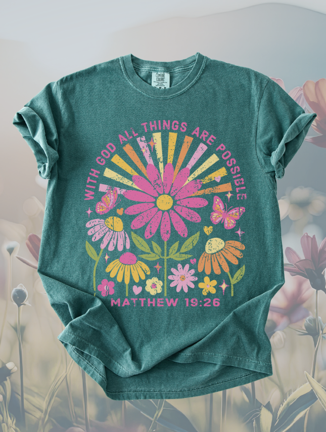 Teal t-shirt featuring a floral design with the text "With God all things are possible" and "Matthew 19:26".
