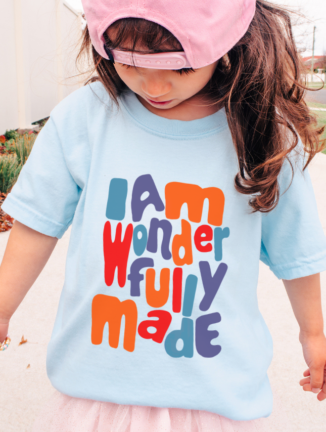 Light blue youth tee featuring the text "I am wonderfully made" in colorful, playful letters.