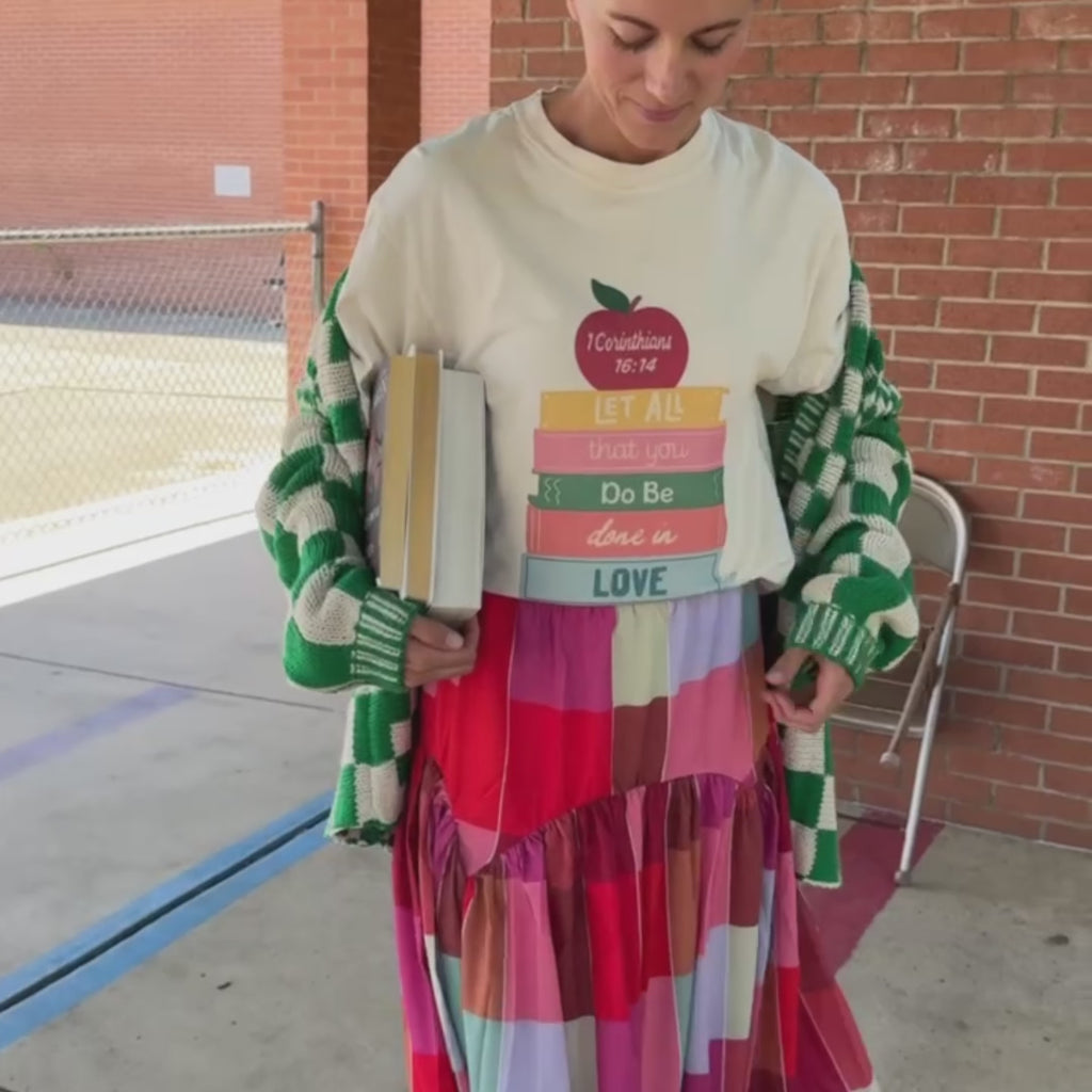 woman wearing love of a teacher tee