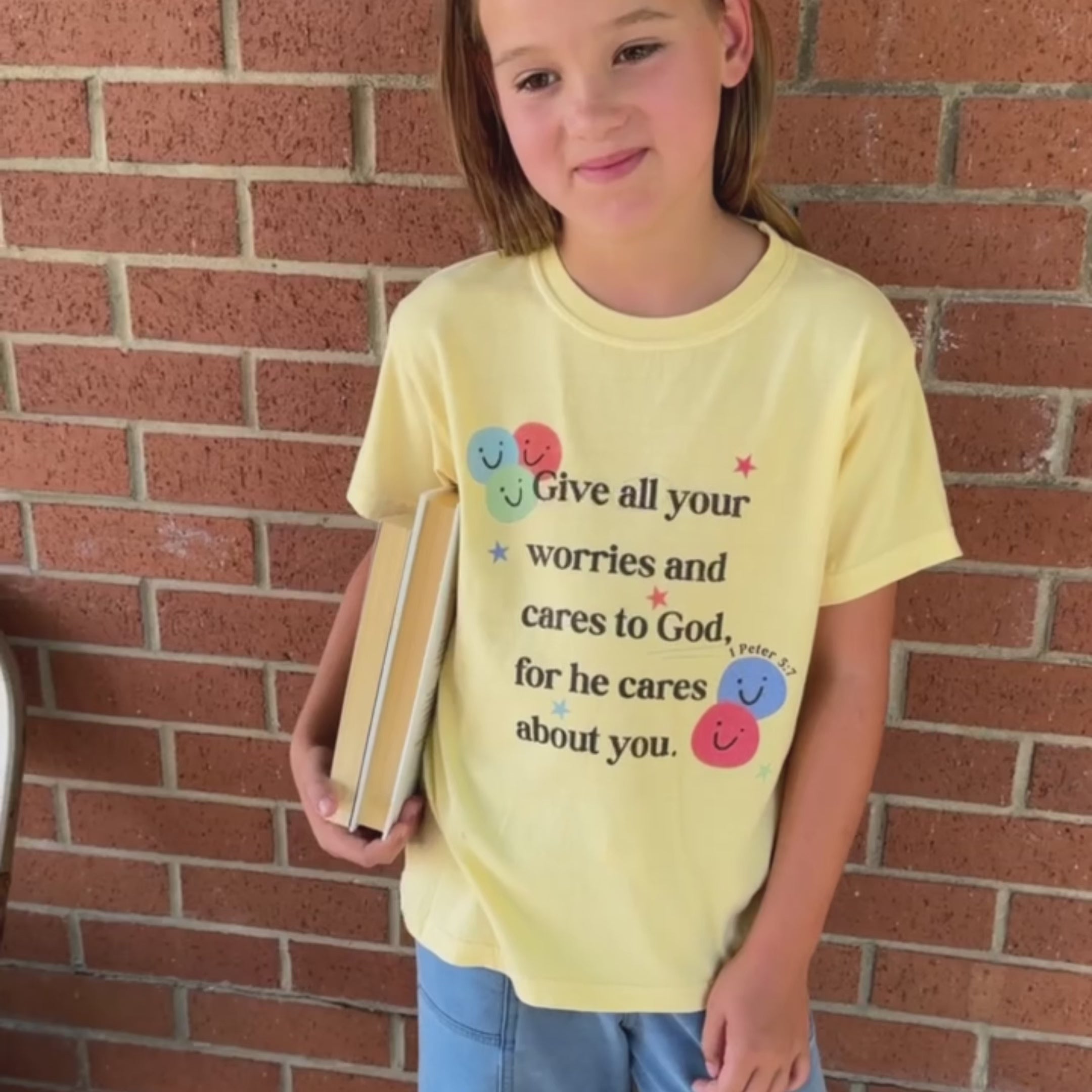 girl wearing give all your worries tee