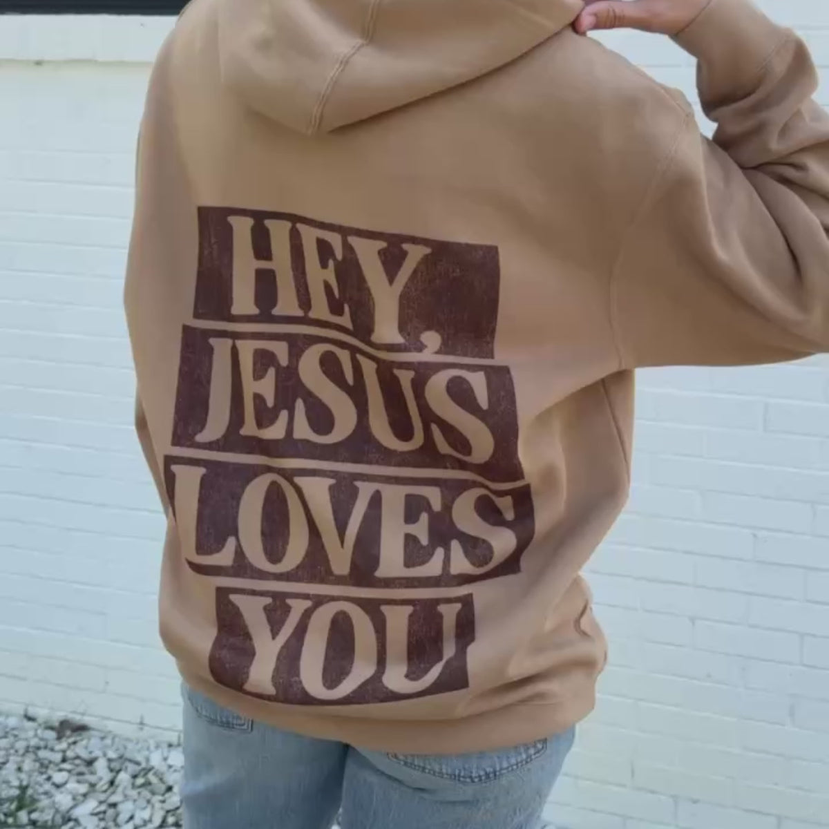 woman wearing hey jesus loves you