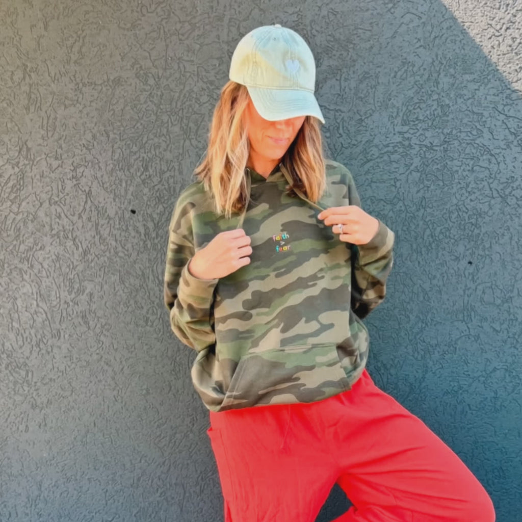 woman wearing faith over fear hoodie
